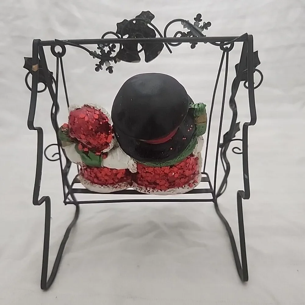 Swinging Snowman Couple Adorned With Glitter, Snowflakes, Bells, And Holly Berry